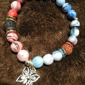 Butterfly beaded stretchy bracelet. Two toned with silver charm. New original